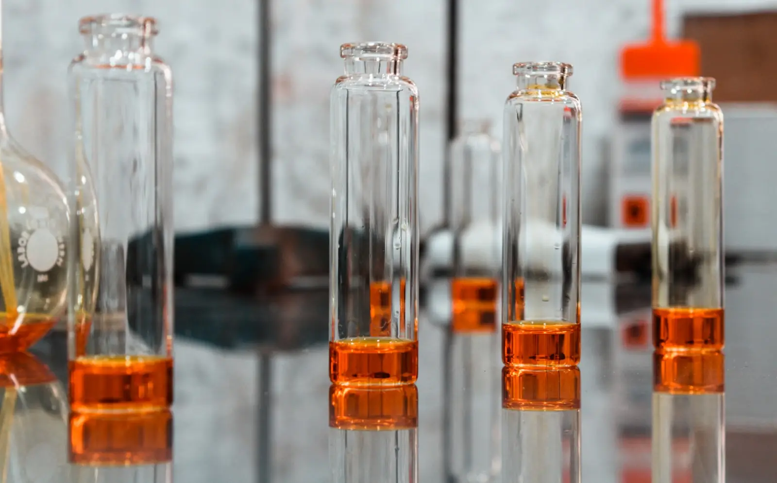 Glass laboratory vials on a dark surface
